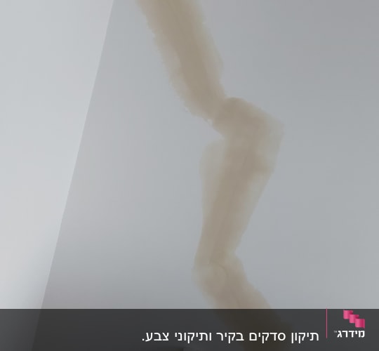 קיר עם תיקוני צבע בצבע בז